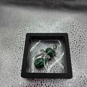 pendant shaped like a cat, crafted from polished green malachite stone.